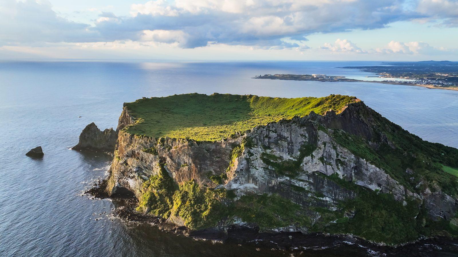 Seongsan Ilchulbong on Jeju's east coast, a When Life Gives You Tangerines filming location (location photo, not a drama still)